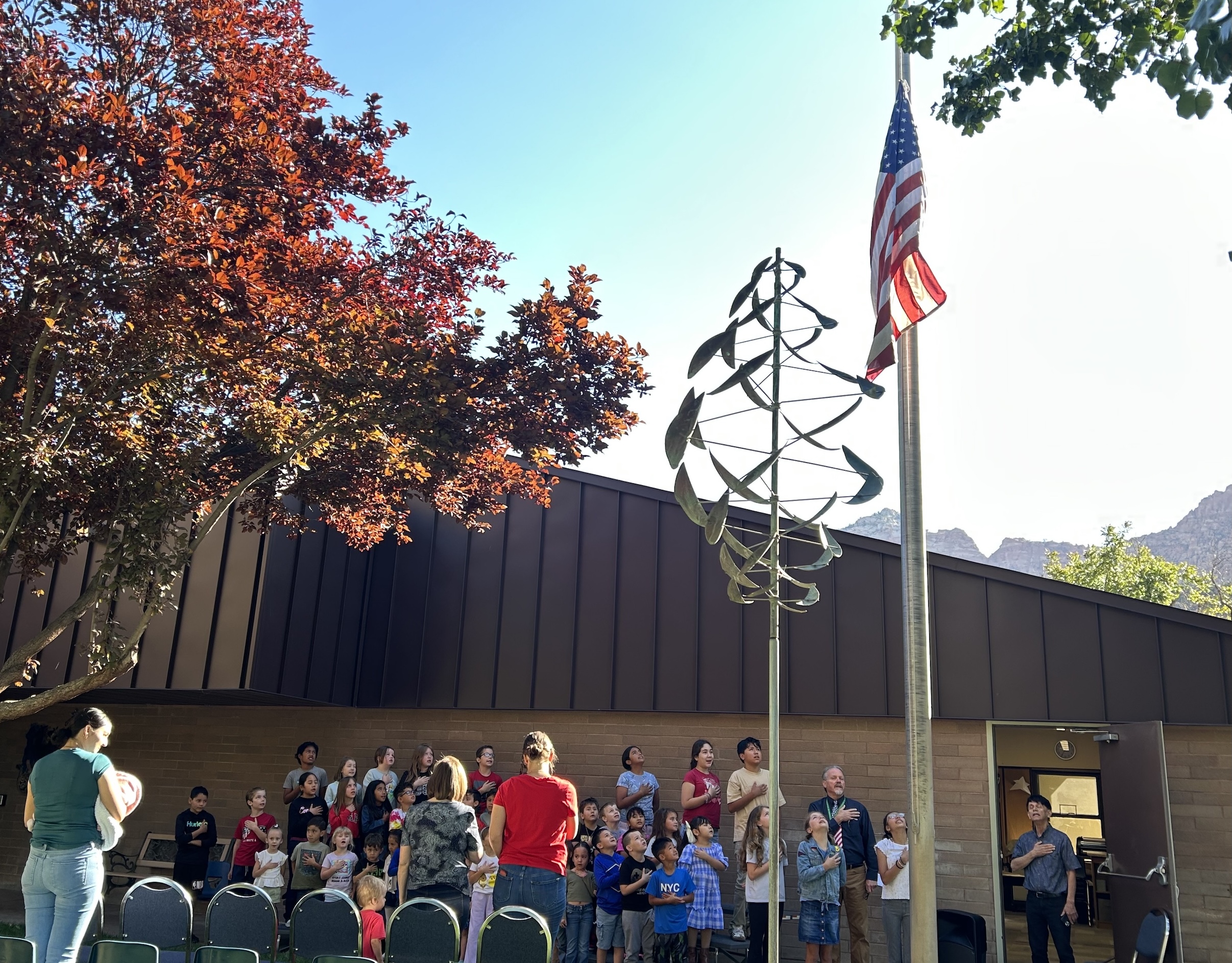 Students singing "The National Anthem" after raising the flag on Hero Day.
