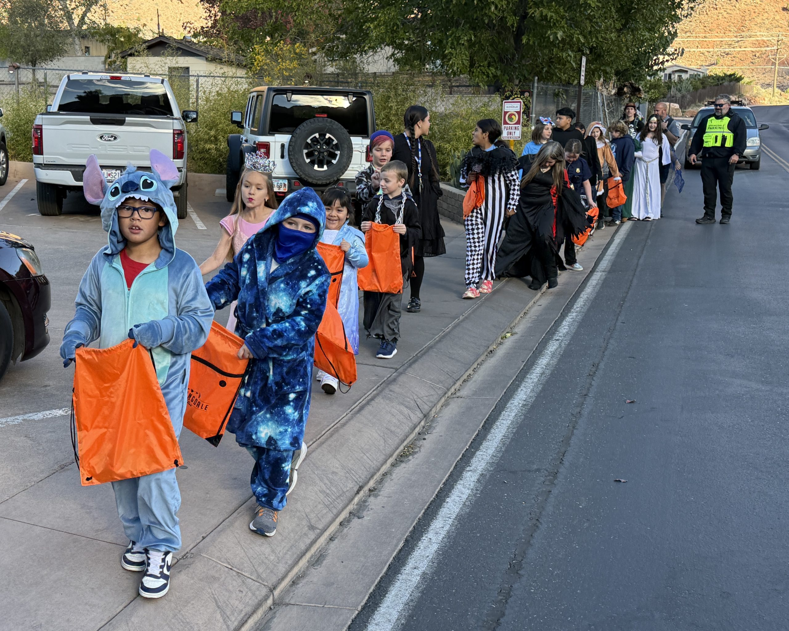 Students in costumes walking in a Halloween Parade
