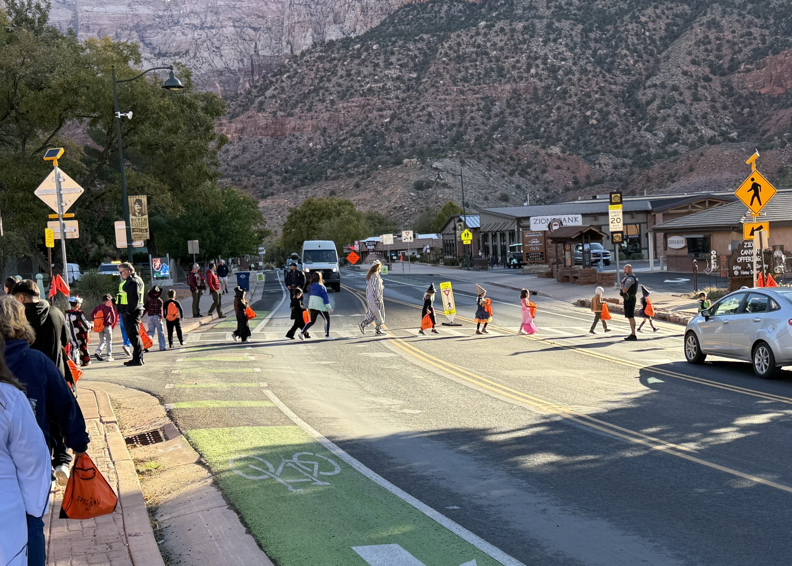 Students in costumes Crossing a Street in a Halloween Parade