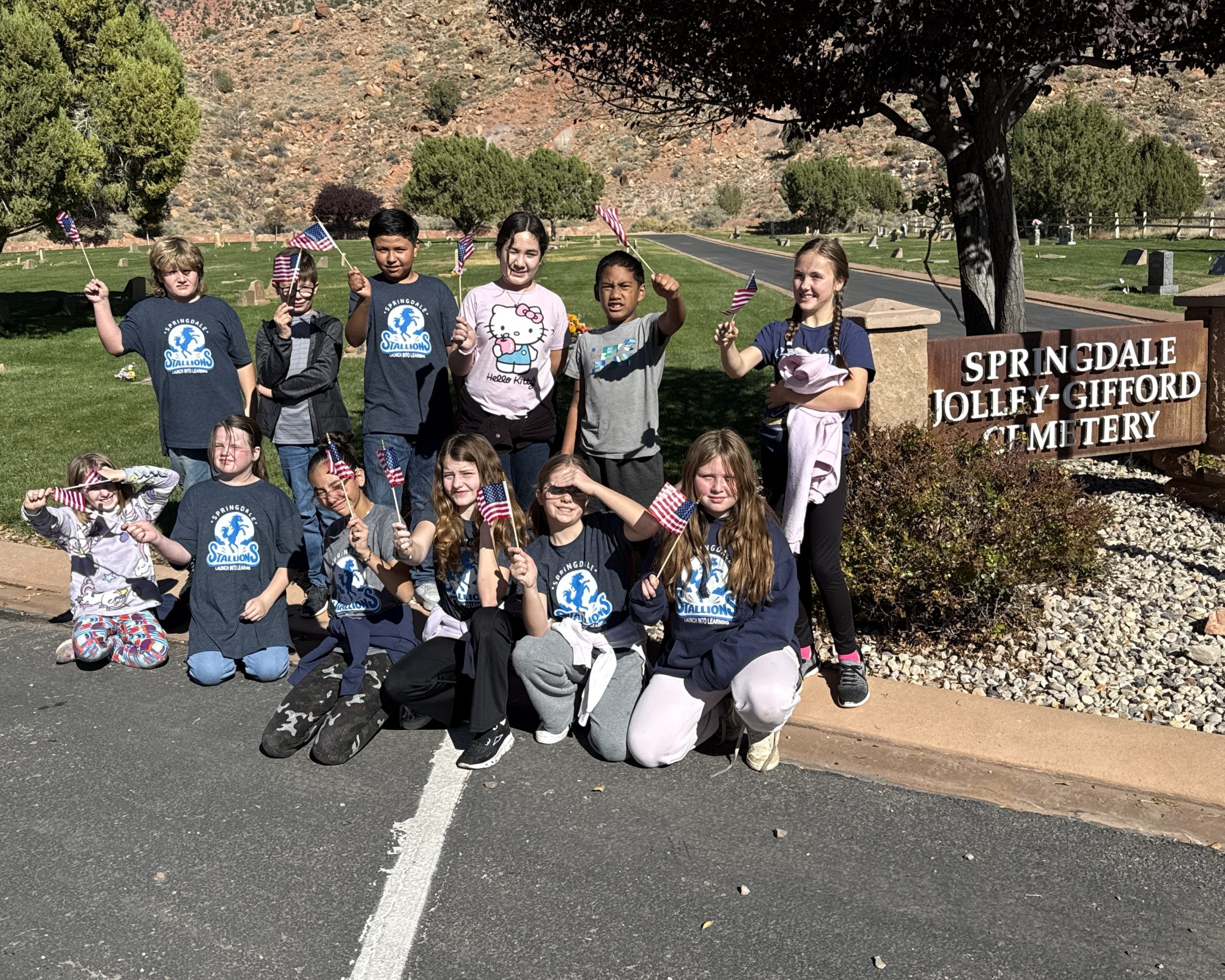 Students paying tribute by setting flags on veterans’ graves